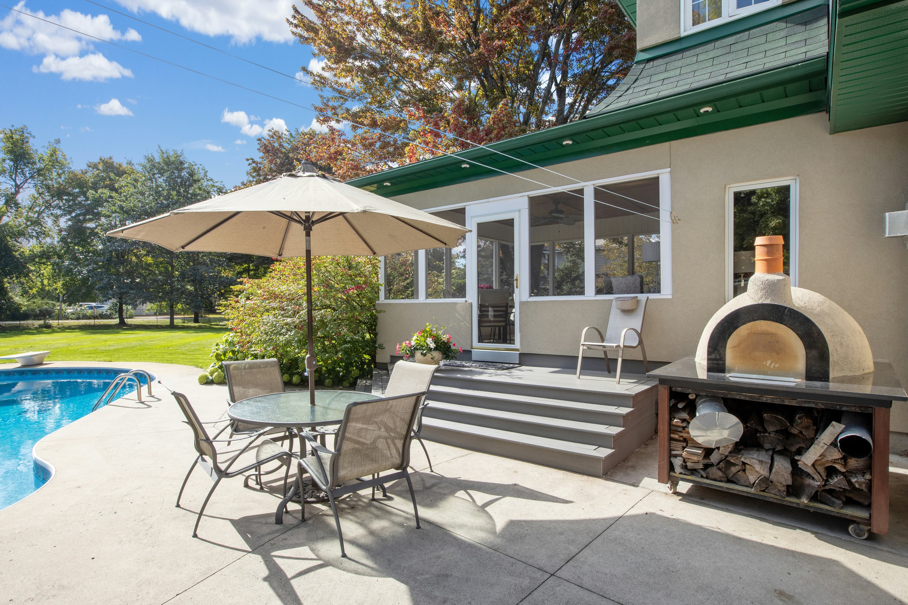 Backyard with pool and wood-fired pizza oven