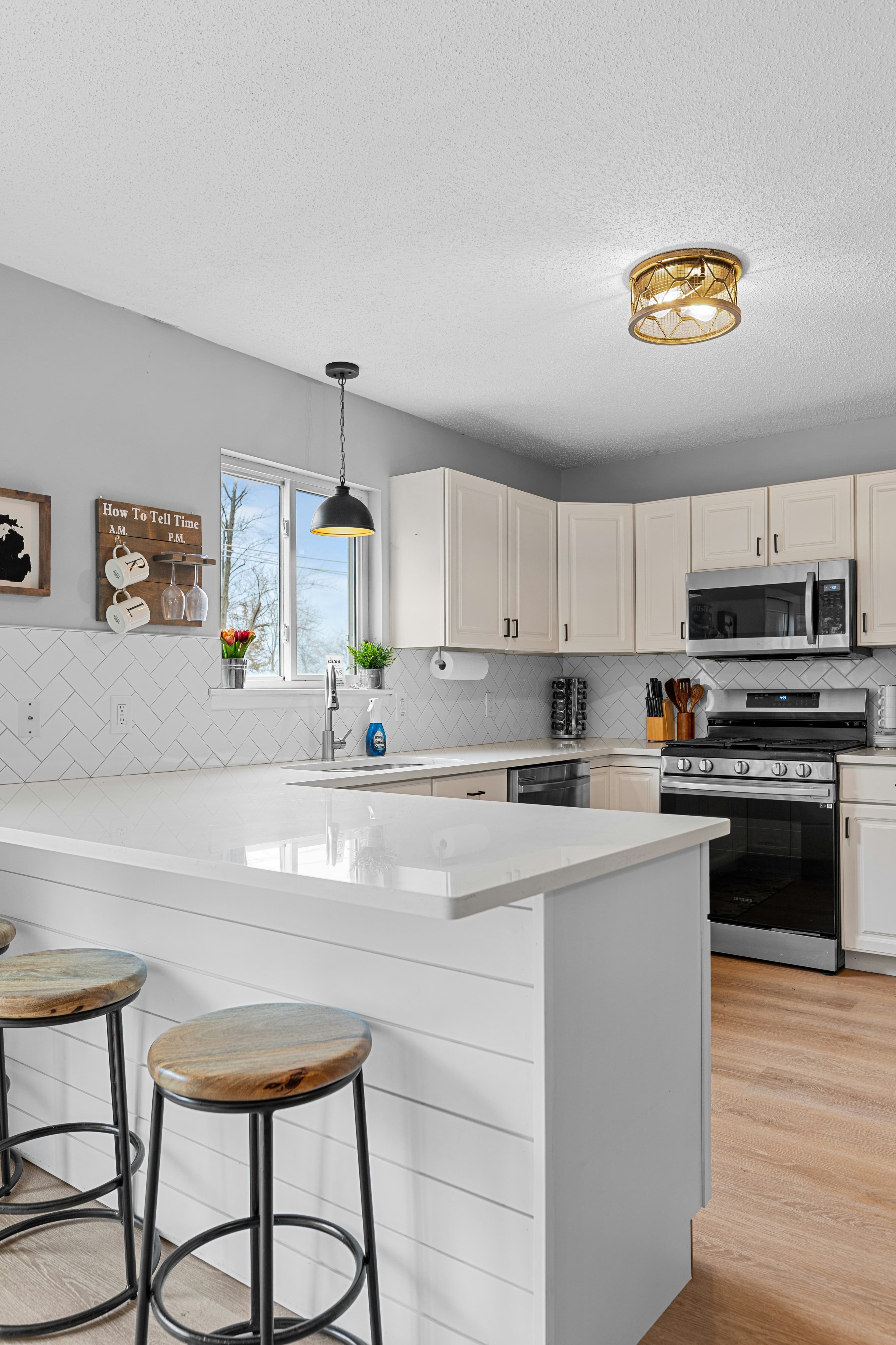 Renovated white kitchen with shiplap bar