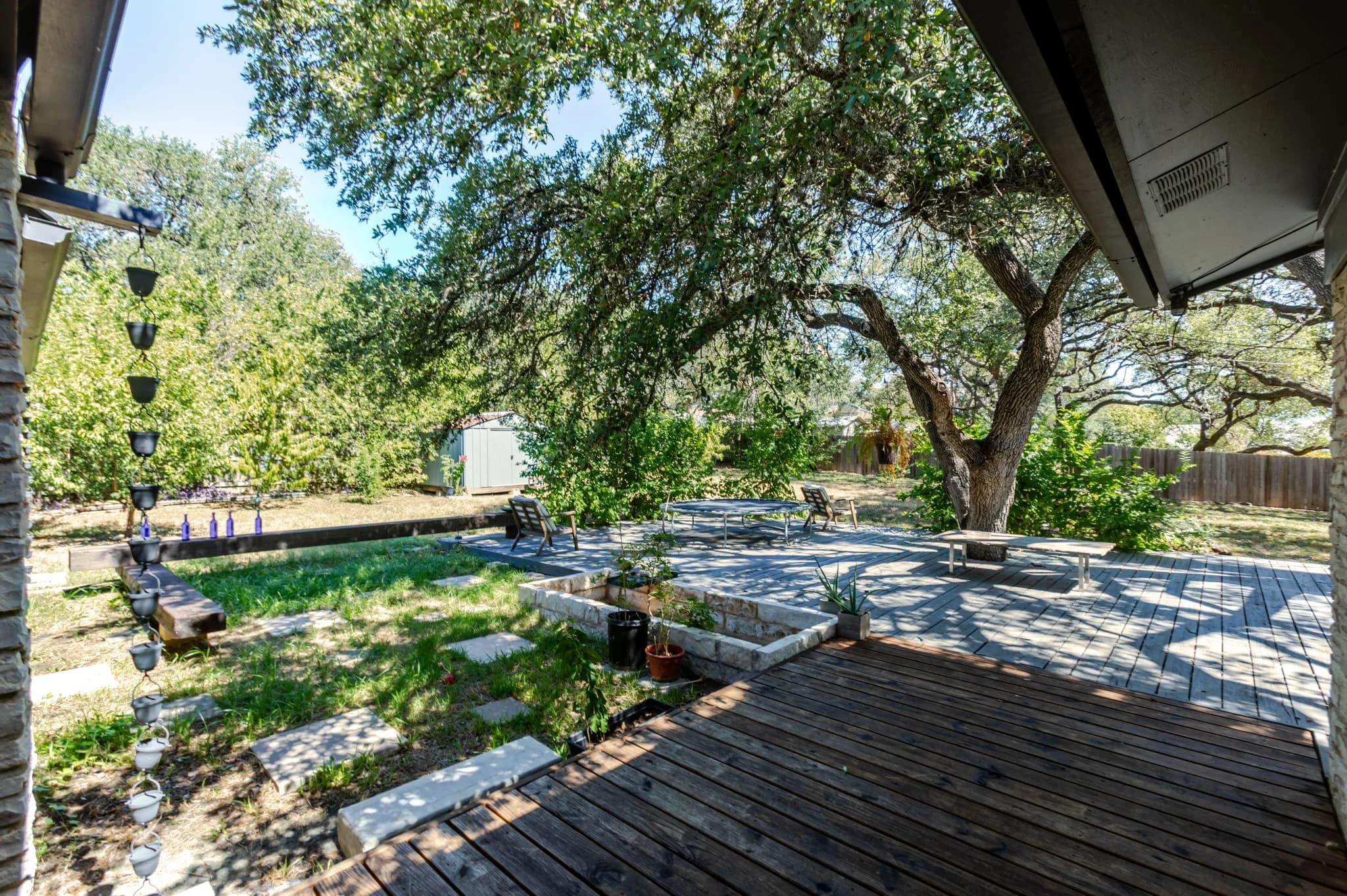 Wood back deck shaded by mature live oak branches